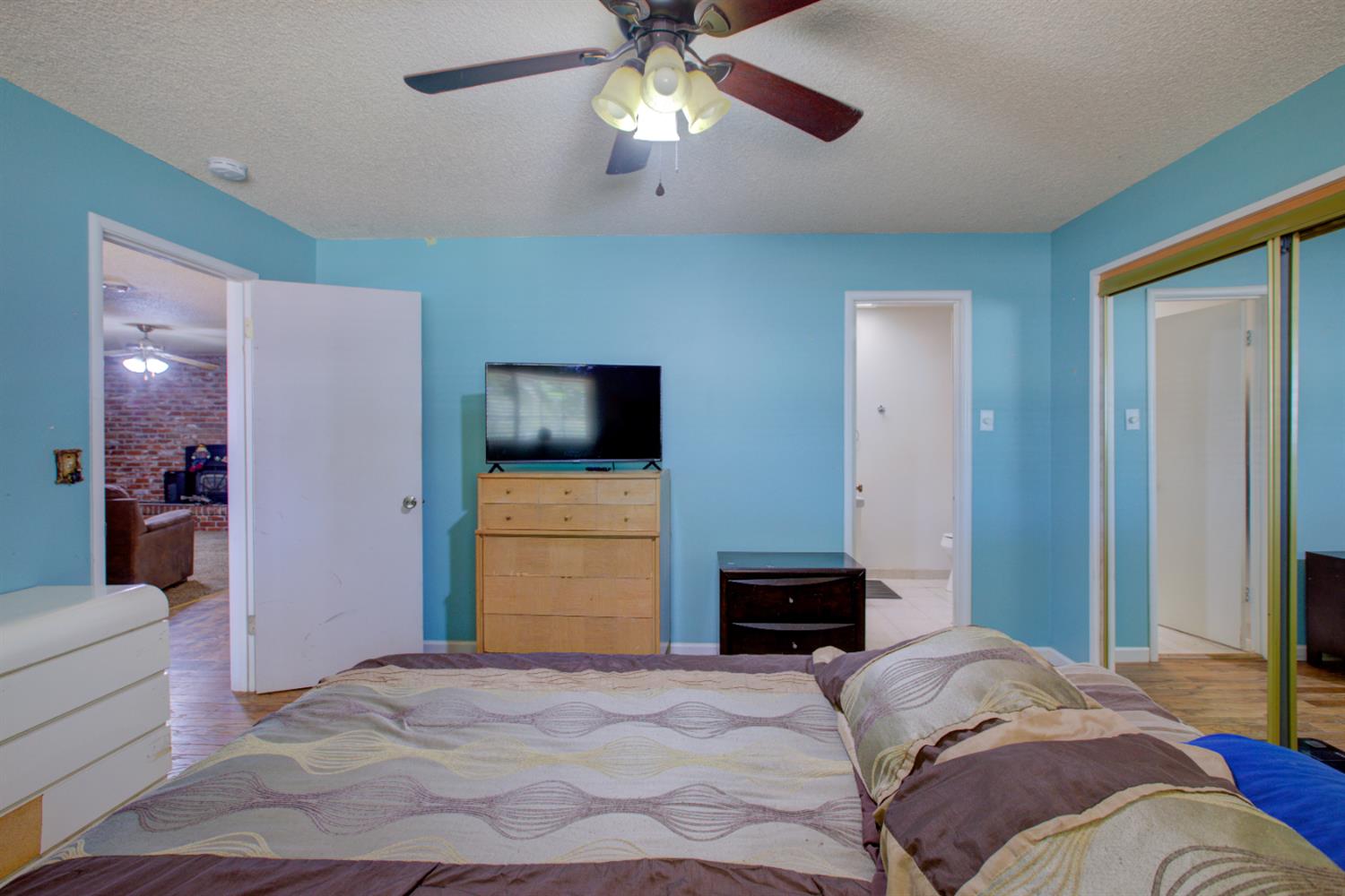 2982 Sequoia Drive Merced, CA 95340 - Photo 24 of 33 a bedroom with a bed and a flat tv screen on dresser