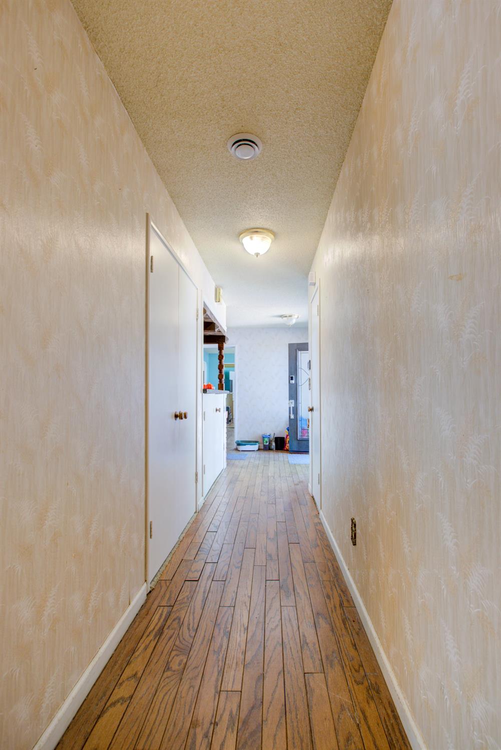 2982 Sequoia Drive Merced, CA 95340 - Photo 25 of 33 a view of a hallway with wooden floor