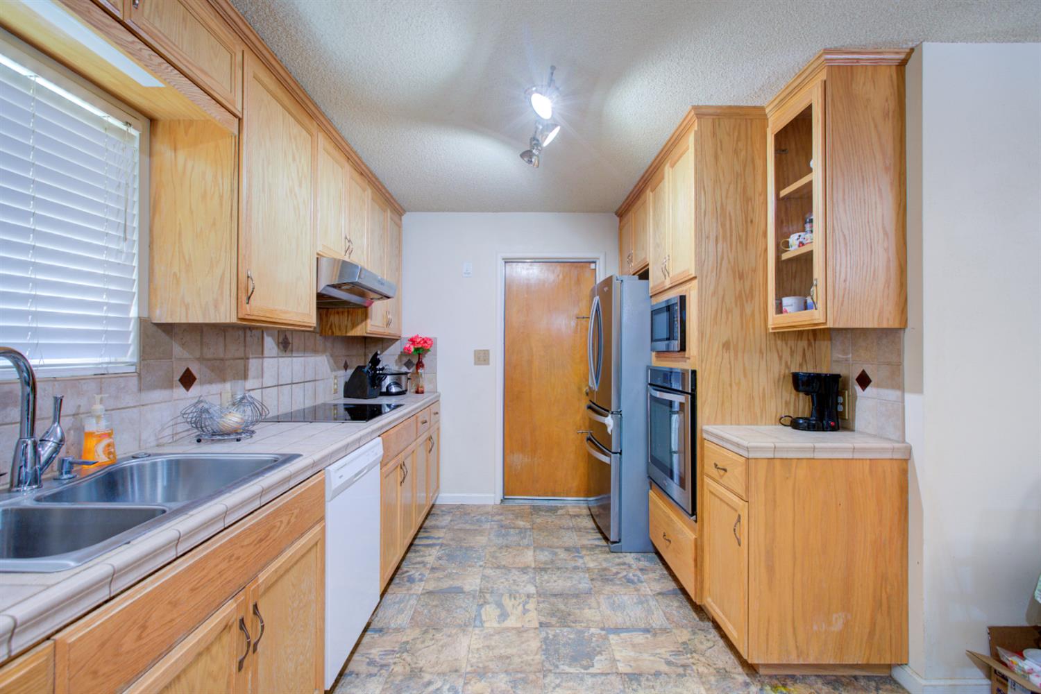 2982 Sequoia Drive Merced, CA 95340 - Photo 6 of 33 a kitchen with stainless steel appliances granite countertop a sink stove and refrigerator