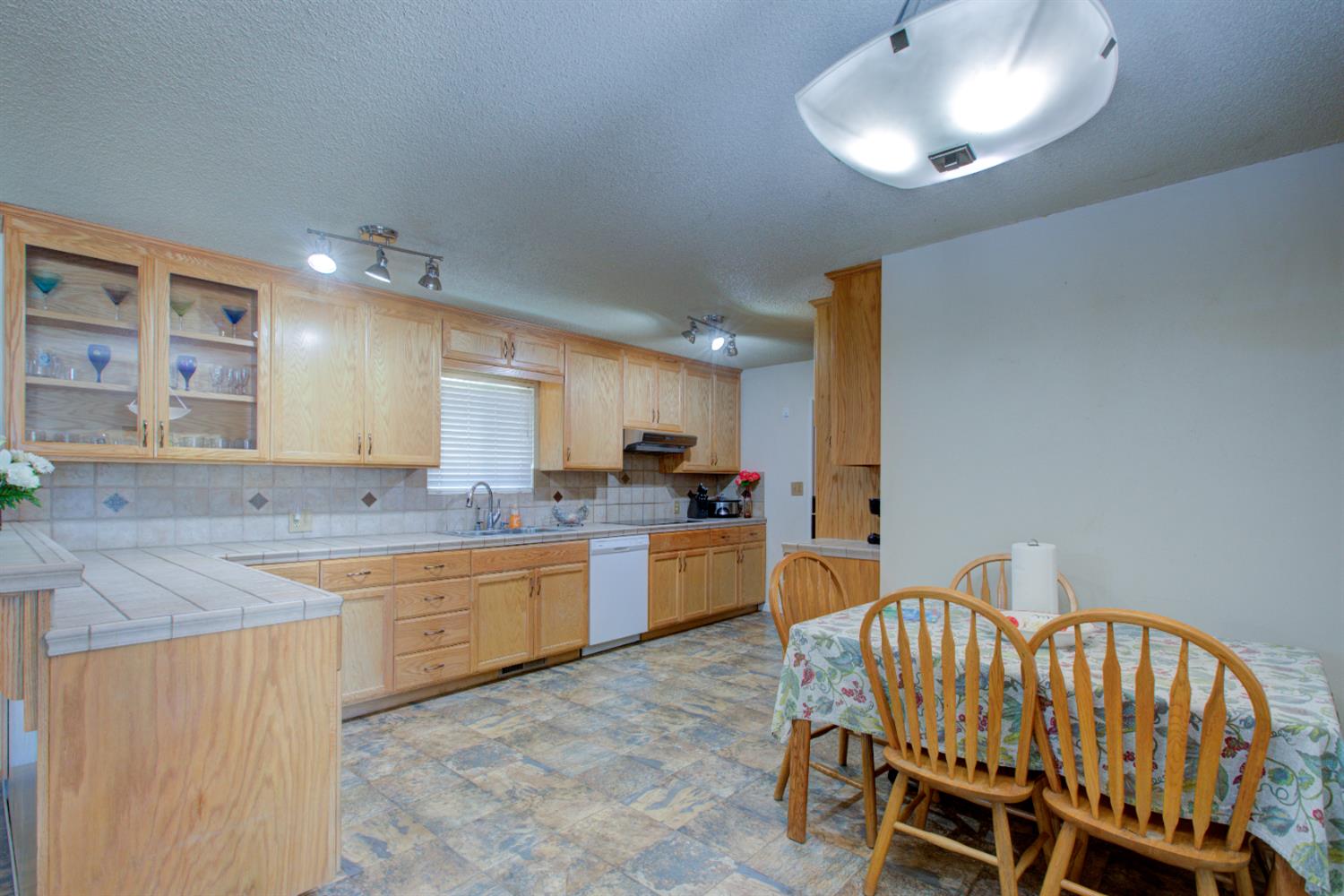 2982 Sequoia Drive Merced, CA 95340 - Photo 8 of 33 a large kitchen with a table and chairs