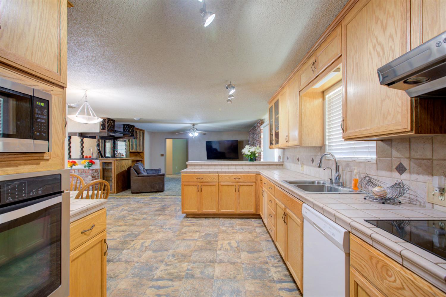 2982 Sequoia Drive Merced, CA 95340 - Photo 10 of 33 a kitchen with stainless steel appliances granite countertop a stove and a sink