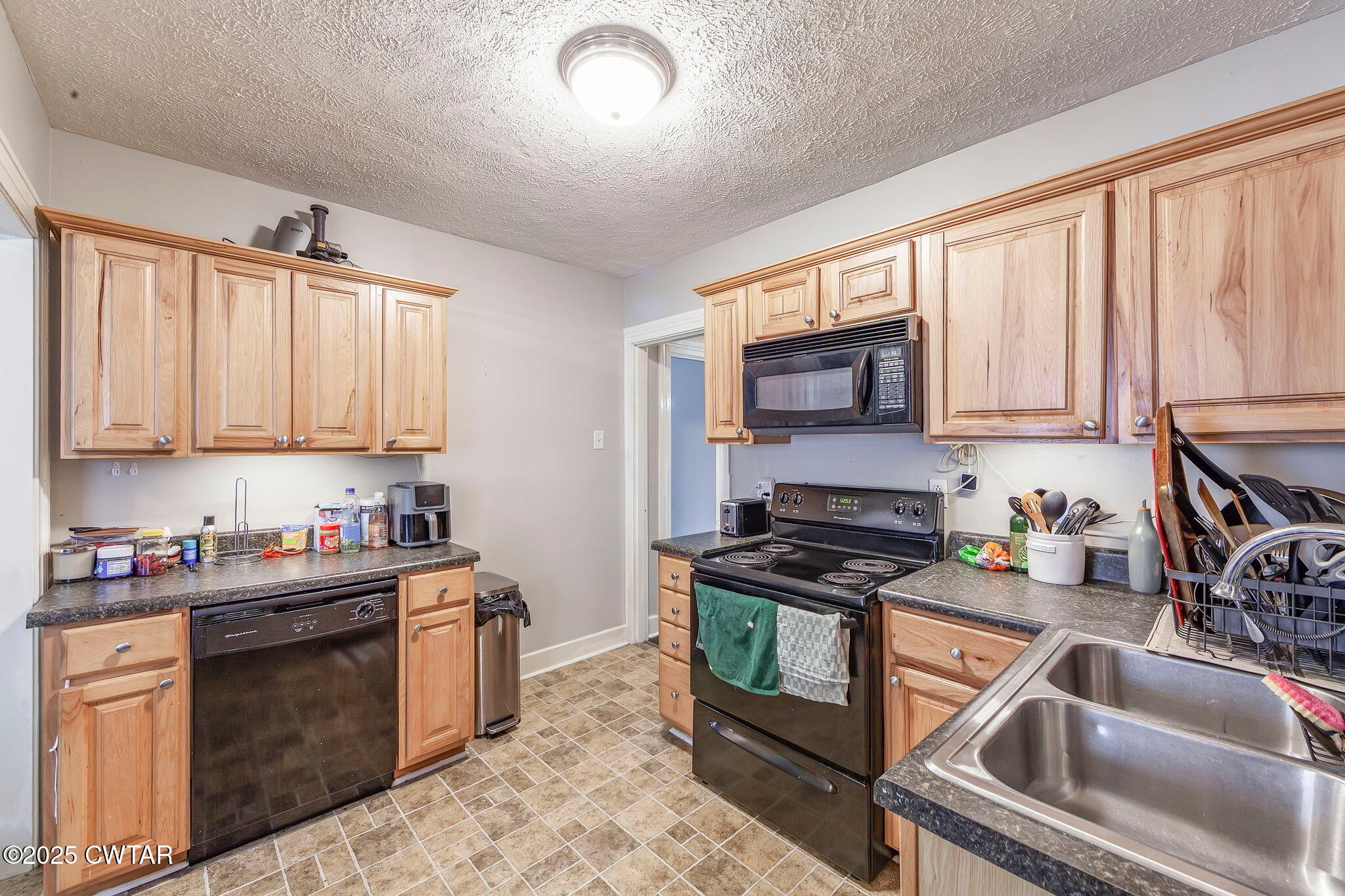 22 Sunset Avenue Jackson, TN 38301 - Photo 5 of 15 a kitchen with granite countertop a stove sink and cabinets