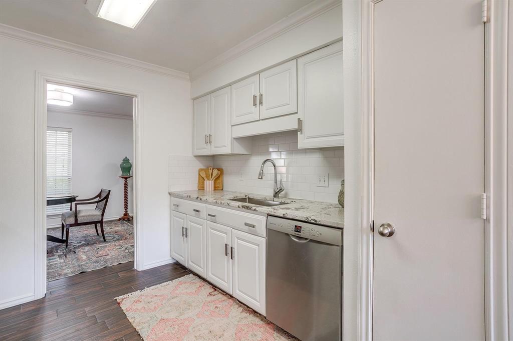 1147 Roaring Springs Road Fort Worth, TX 76114 - Photo 14 of 36 a kitchen with stainless steel appliances granite countertop a sink and cabinets