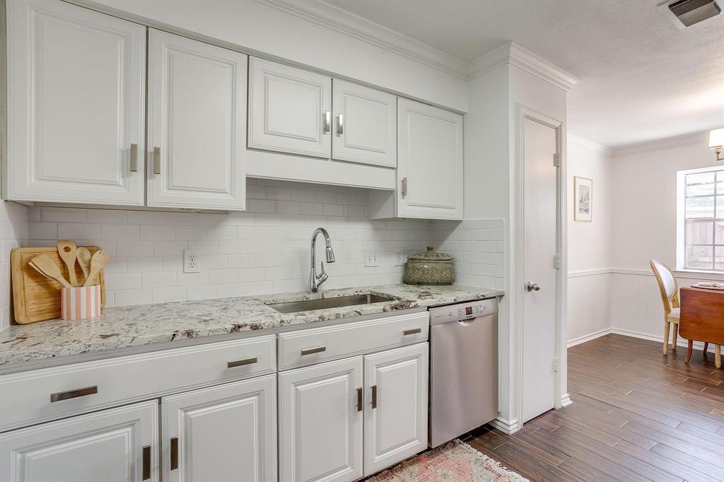 1147 Roaring Springs Road Fort Worth, TX 76114 - Photo 15 of 36 a kitchen with granite countertop white cabinets and sink