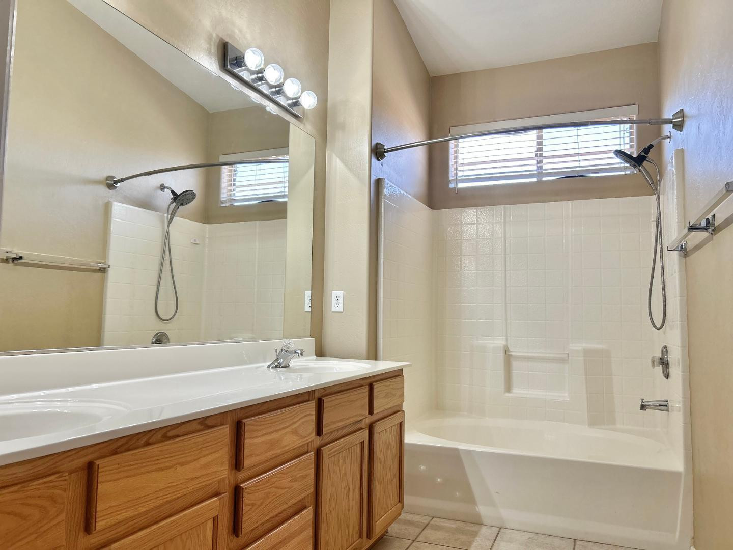 6660 East Roland Street Mesa, AZ 85215 - Photo 9 of 17 a bathroom with a double vanity sink mirror and shower