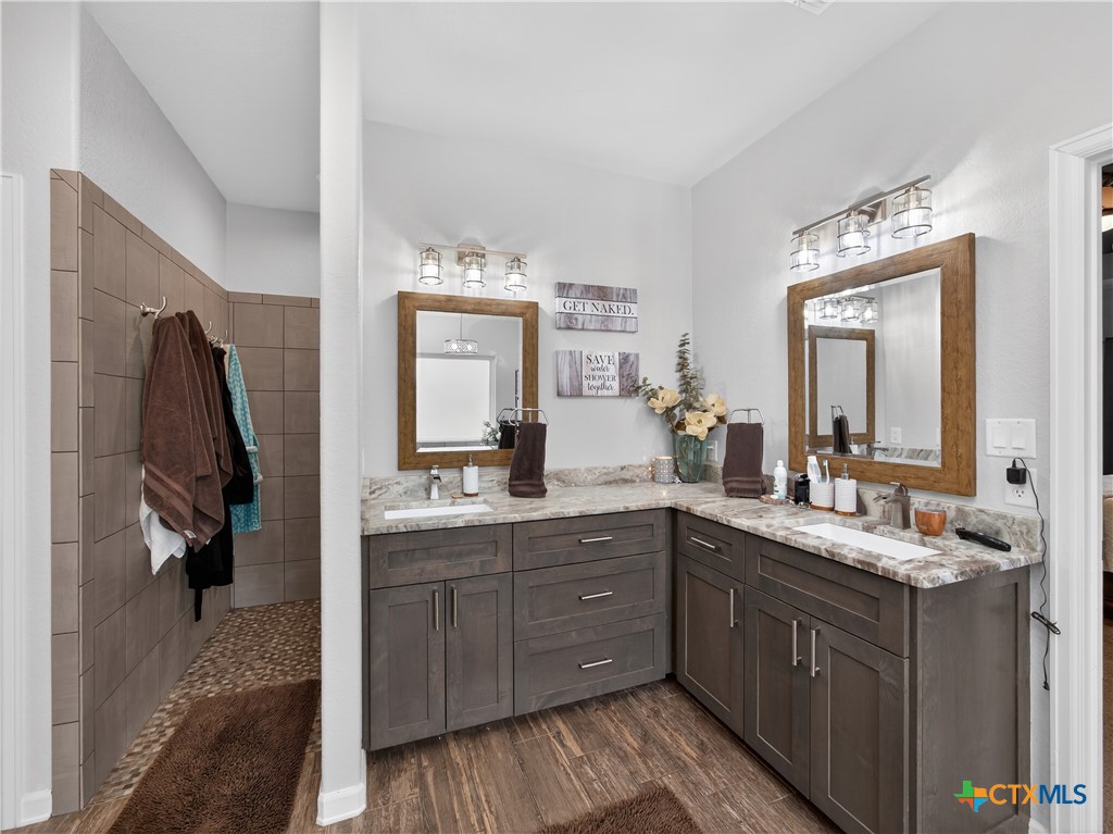 494 Flash Circle Luling, TX 78648 - Photo 16 of 44 a bathroom with a double vanity sink and mirror