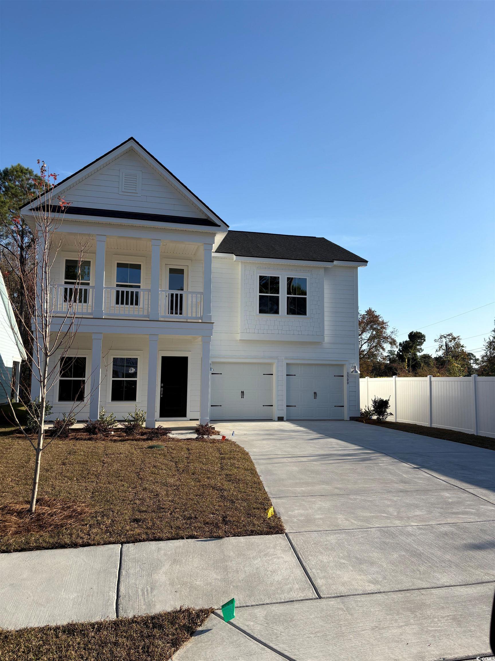 3300 Bay View North Myrtle Beach, SC 29582 - Photo 1 of 33 Greek revival inspired property with a porch, concrete driveway, and a garage