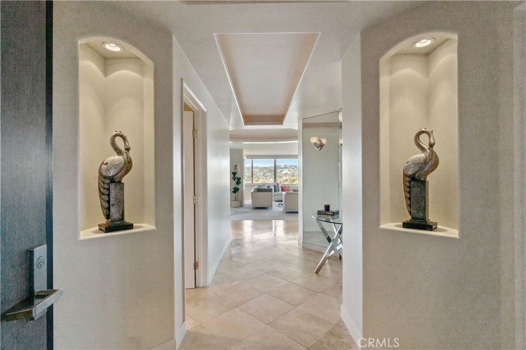 a view of a hallway with wooden floor and a living room