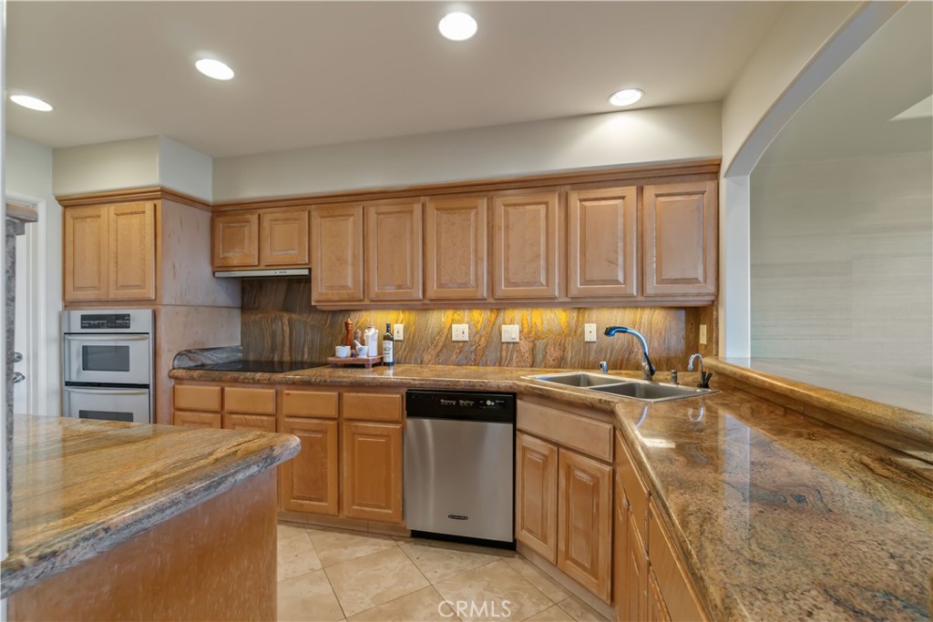 875 Comstock Avenue, Unit 16A Los Angeles, CA 90024 - Photo 11 of 28 a kitchen with stainless steel appliances granite countertop a sink stove and cabinets