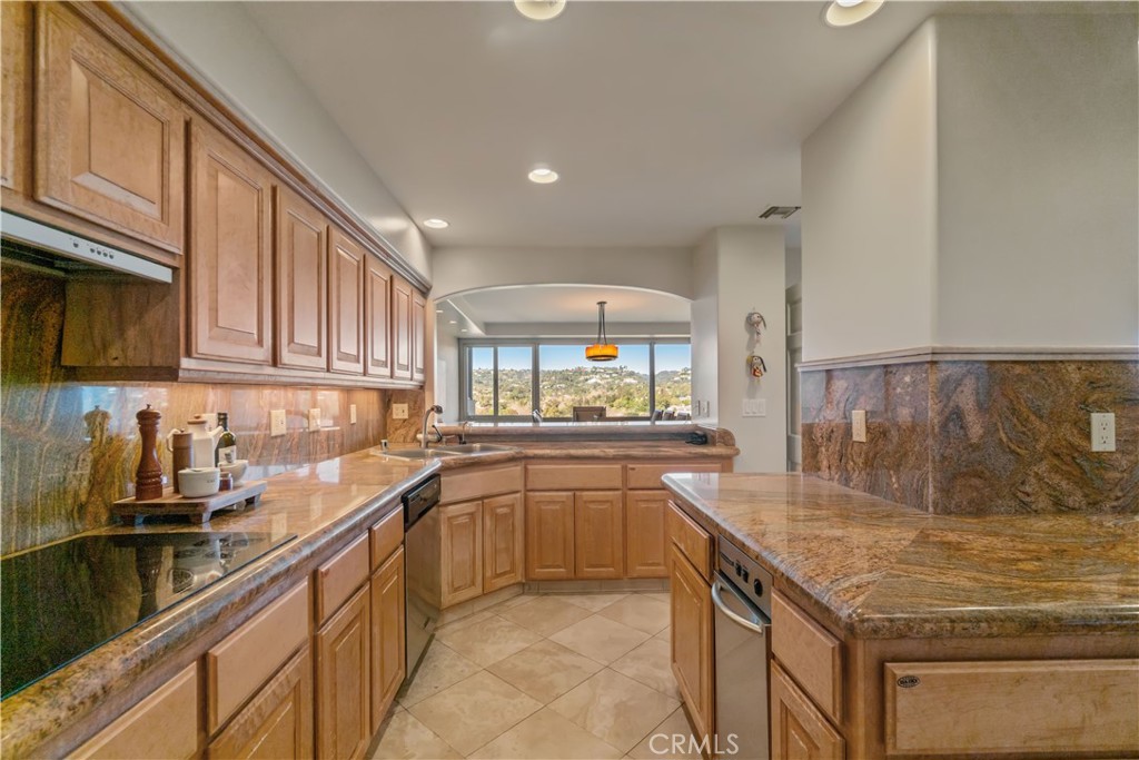875 Comstock Avenue, Unit 16A Los Angeles, CA 90024 - Photo 12 of 28 a kitchen with stainless steel appliances granite countertop a sink and cabinets