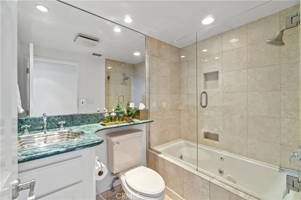 875 Comstock Avenue, Unit 16A Los Angeles, CA 90024 - Photo 18 of 28 a bathroom with a granite countertop sink toilet mirror and bathtub