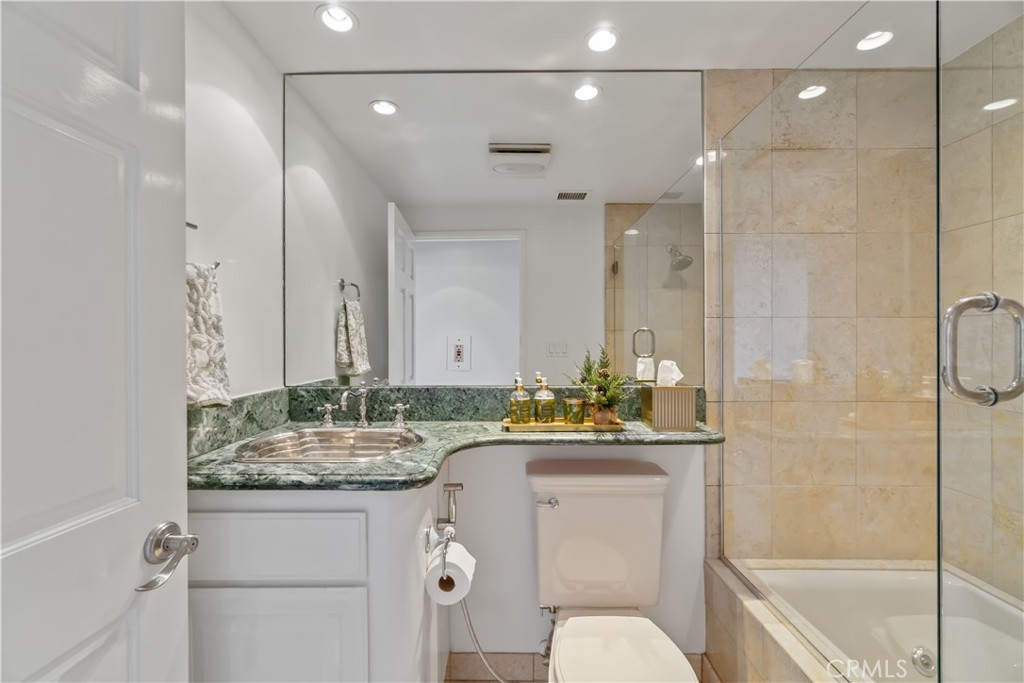 875 Comstock Avenue, Unit 16A Los Angeles, CA 90024 - Photo 19 of 28 a bathroom with a granite countertop sink a toilet and shower