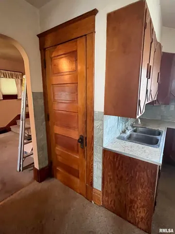 a view of an empty room with a fireplace and a window