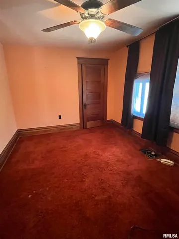 a view of an empty room with windows