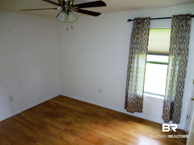 204 West Sycamore Avenue Foley, AL 36535 - Photo 5 of 11 Bedroom with no carpet and light paint on walls.
