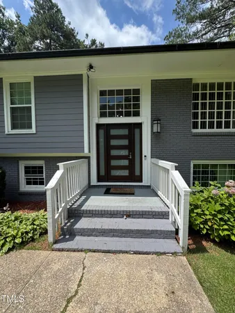 a front view of a house with a garden