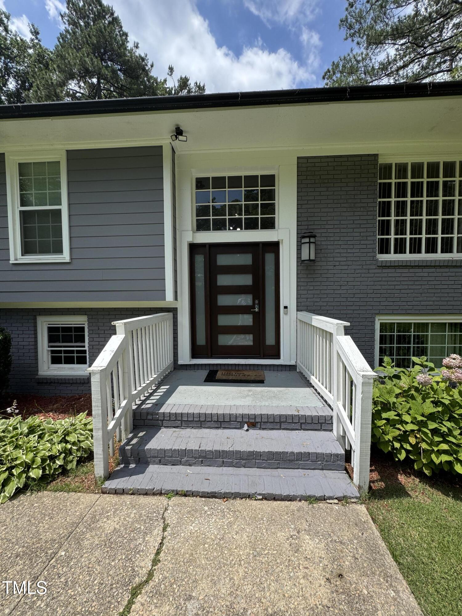 a front view of a house with a garden