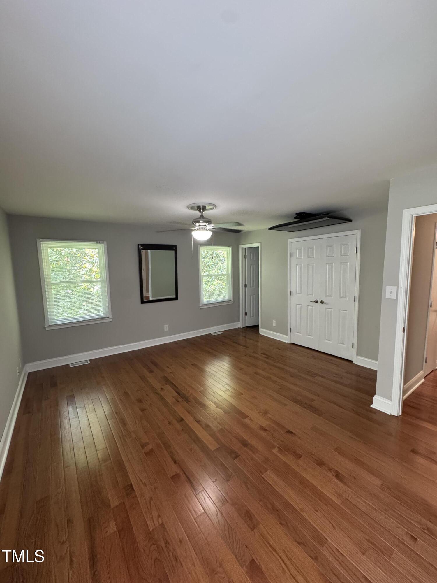 1513 Shelley Road Raleigh, NC 27612 - Photo 12 of 24 an empty room with wooden floor and windows