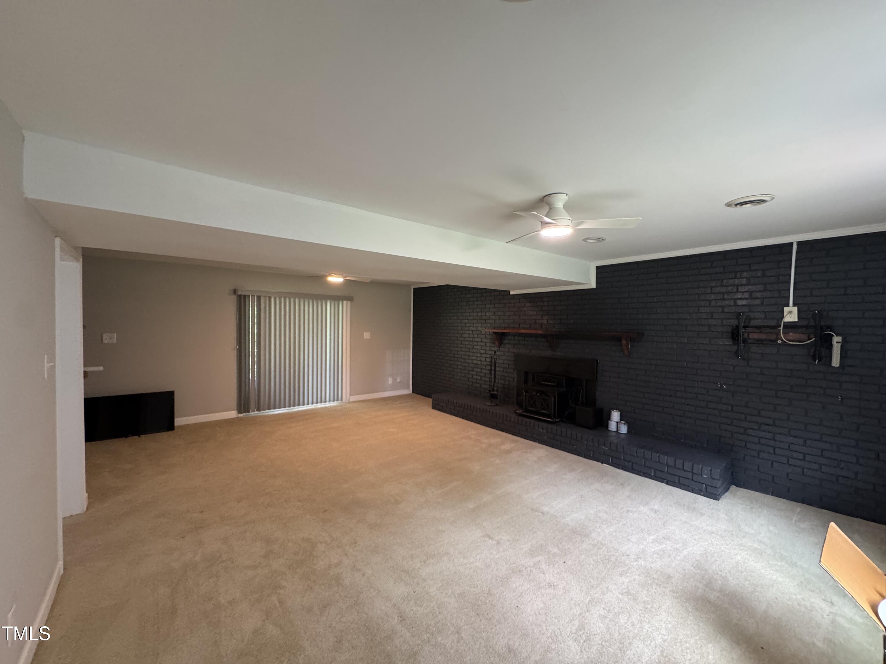 1513 Shelley Road Raleigh, NC 27612 - Photo 14 of 24 a view of an empty room with a fireplace