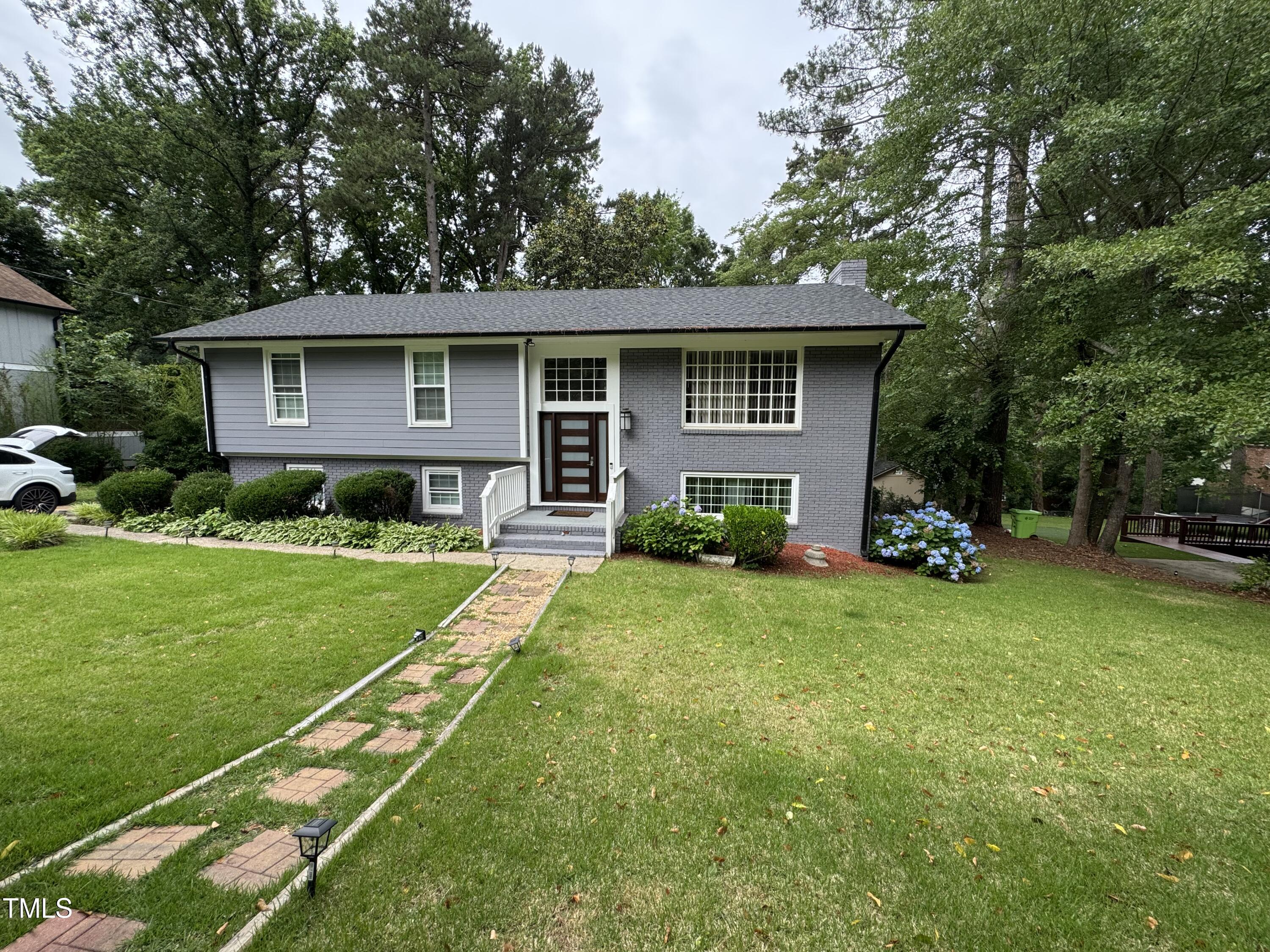 1513 Shelley Road Raleigh, NC 27612 - Photo 2 of 24 a front view of a house with a yard and trees