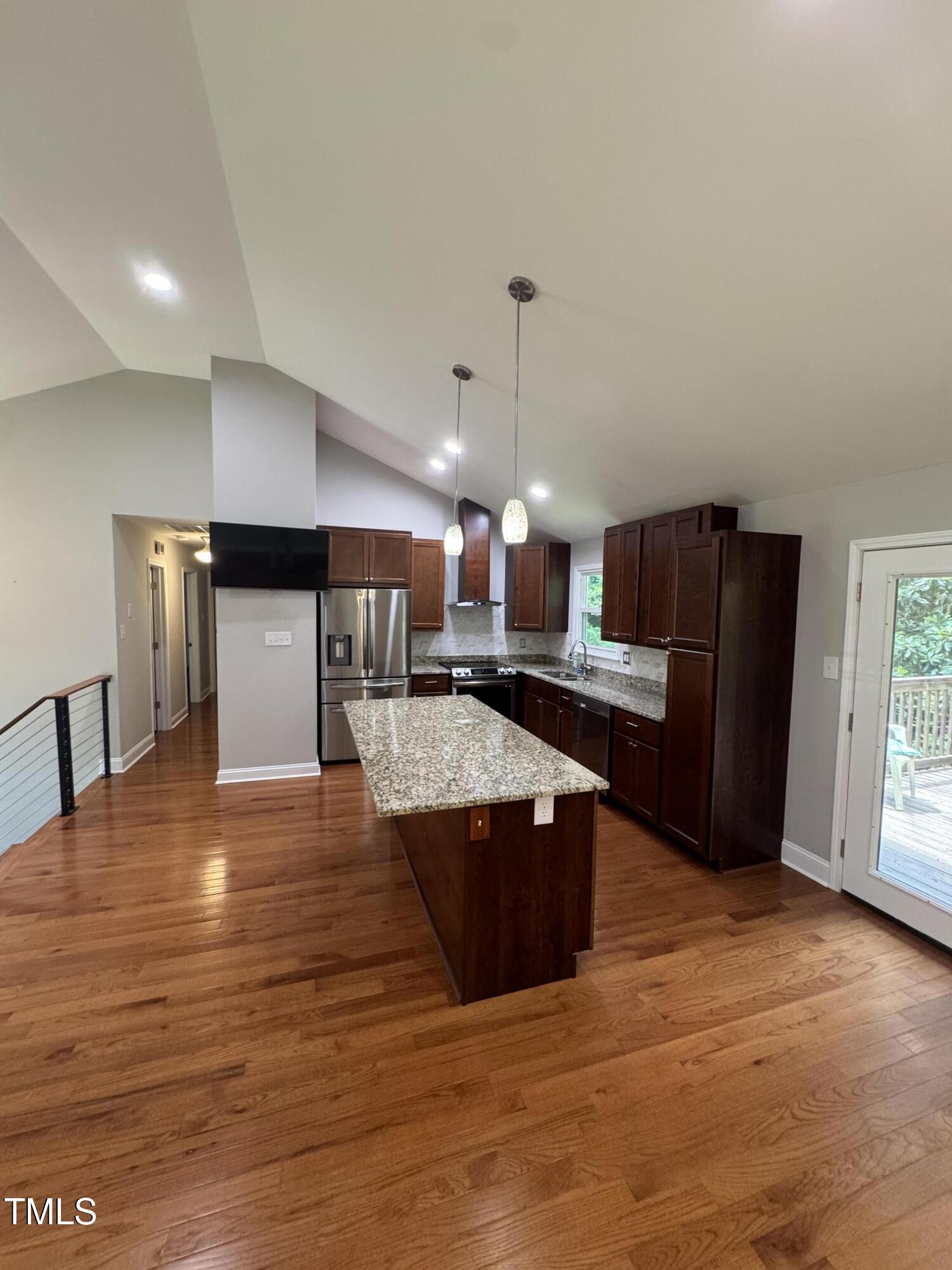 1513 Shelley Road Raleigh, NC 27612 - Photo 6 of 24 a kitchen with stainless steel appliances kitchen island granite countertop a refrigerator a sink and a stove