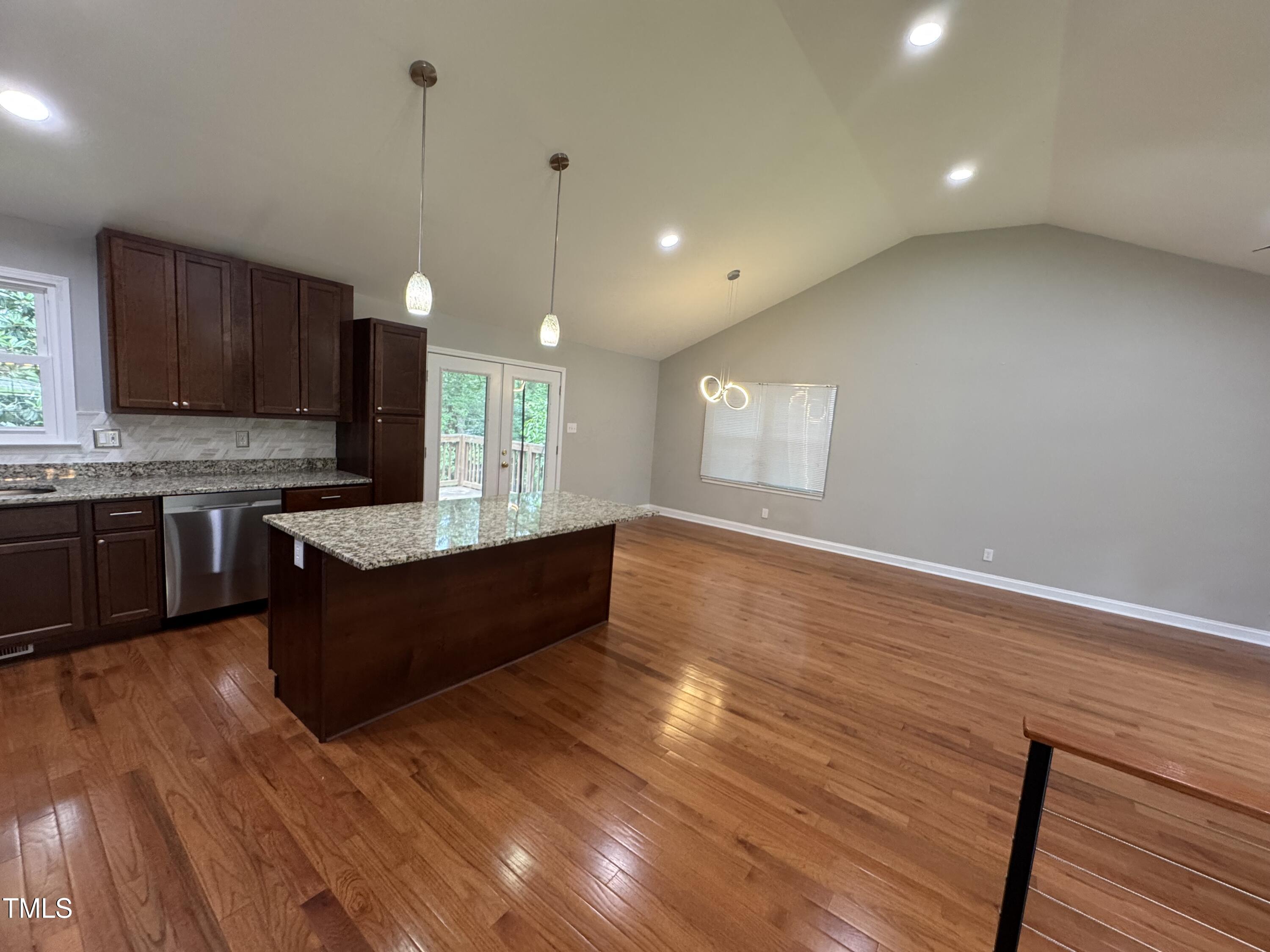 1513 Shelley Road Raleigh, NC 27612 - Photo 8 of 24 a large kitchen with wooden floors and stainless steel appliances