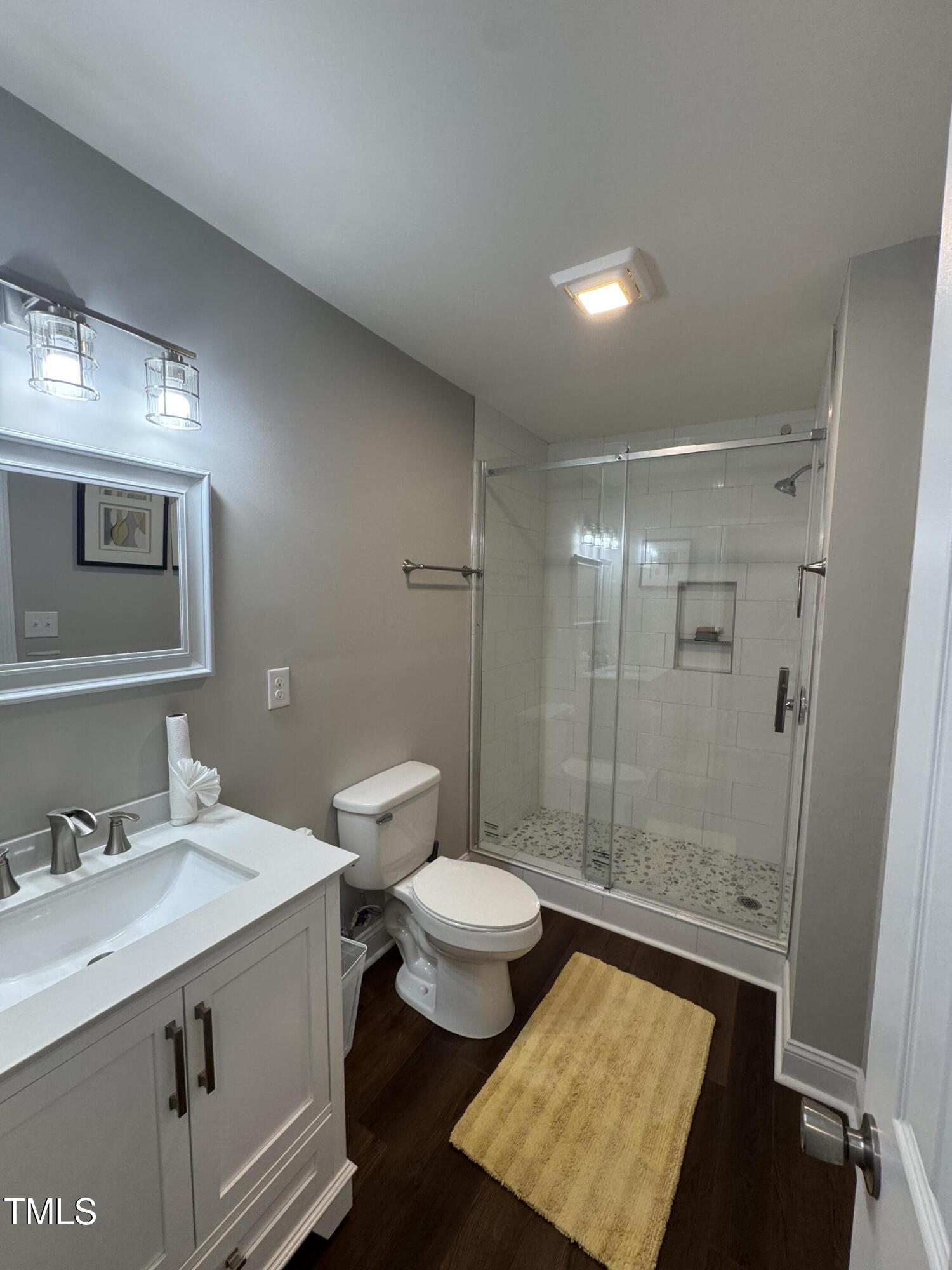 1513 Shelley Road Raleigh, NC 27612 - Photo 9 of 24 a bathroom with a sink toilet and shower