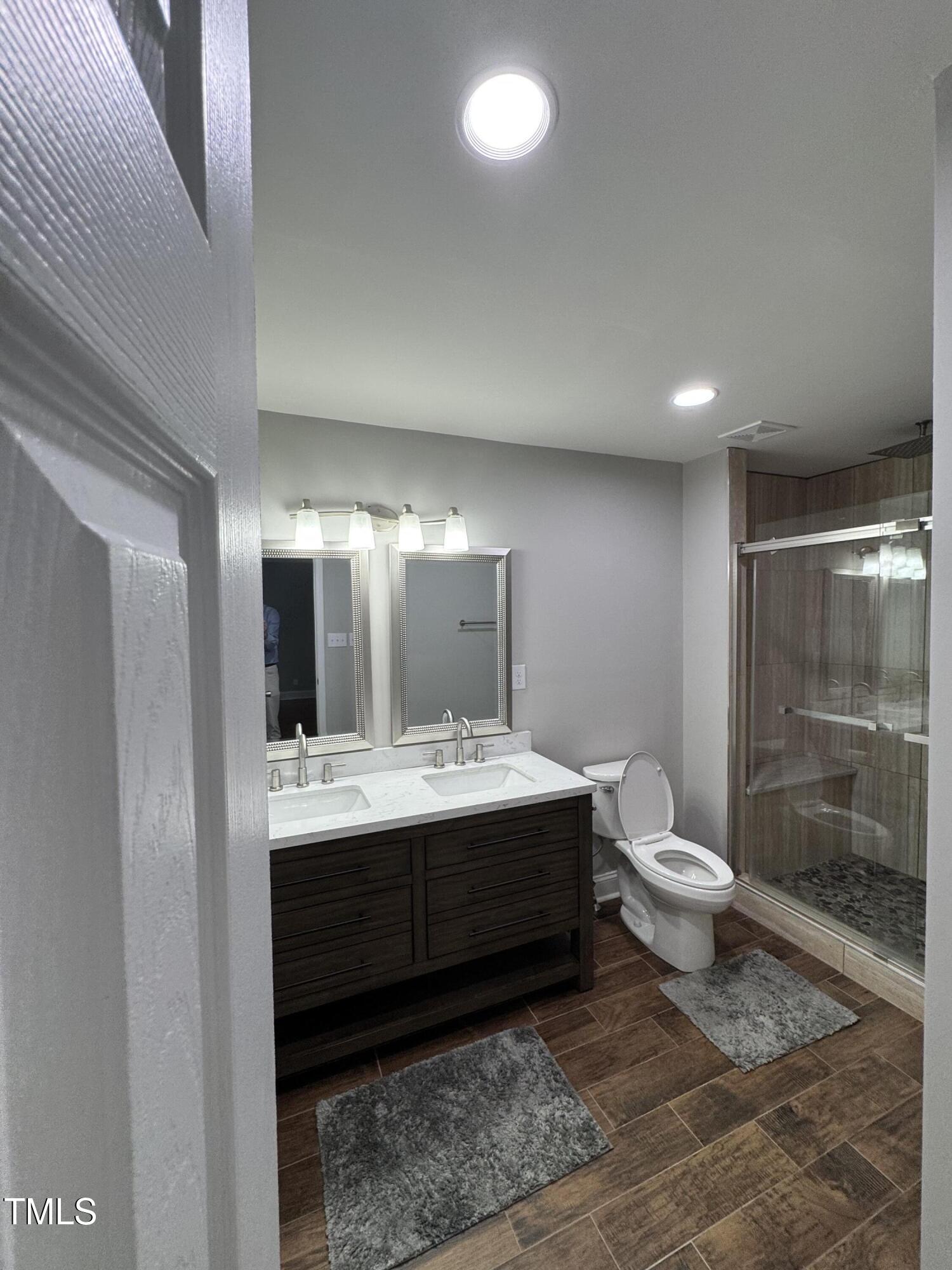 1513 Shelley Road Raleigh, NC 27612 - Photo 10 of 24 a bathroom with a sink toilet and shower