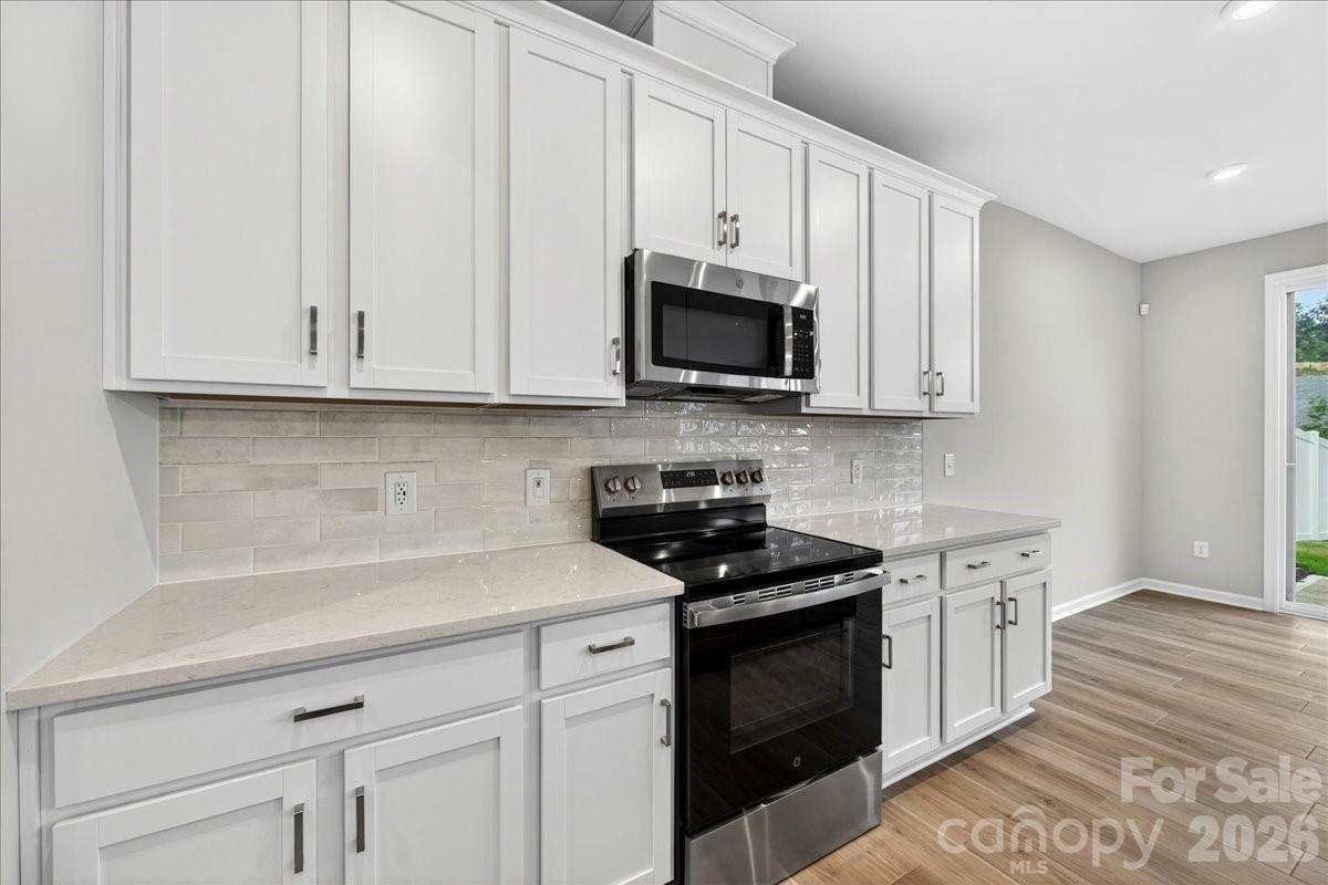 512 Webster Lane Cramerton, NC 28032 - Photo 6 of 28 a kitchen with stainless steel appliances granite countertop grey cabinets a sink and dishwasher