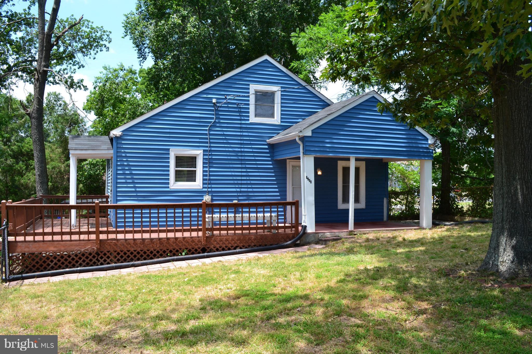 9300 Sanger Street Lorton, VA 22079 - Photo 1 of 16 a view of a house with a yard potted plants and a large tree