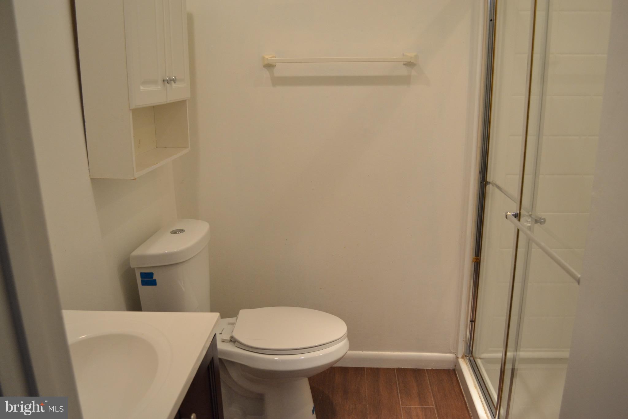 9300 Sanger Street Lorton, VA 22079 - Photo 11 of 16 a white toilet sitting next to a small sink