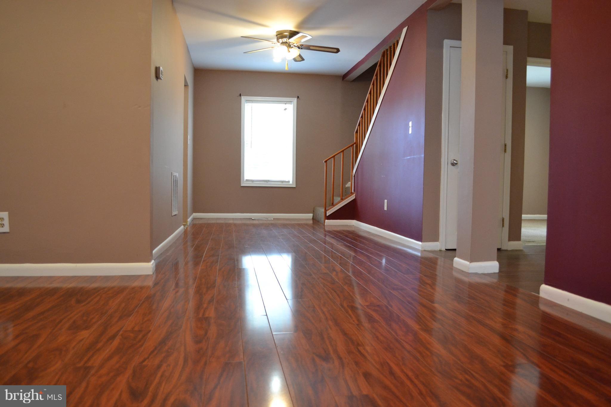 9300 Sanger Street Lorton, VA 22079 - Photo 7 of 16 wooden floor in an empty room with a window