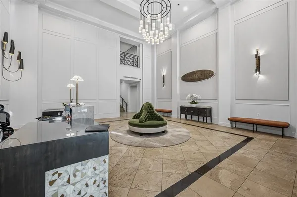 a living room with furniture and a chandelier