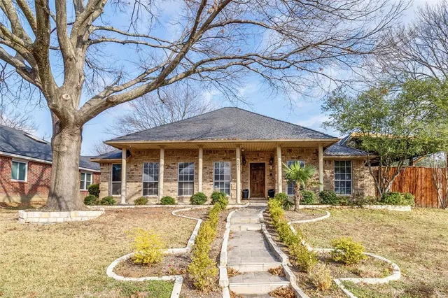 a view of a house with a yard patio