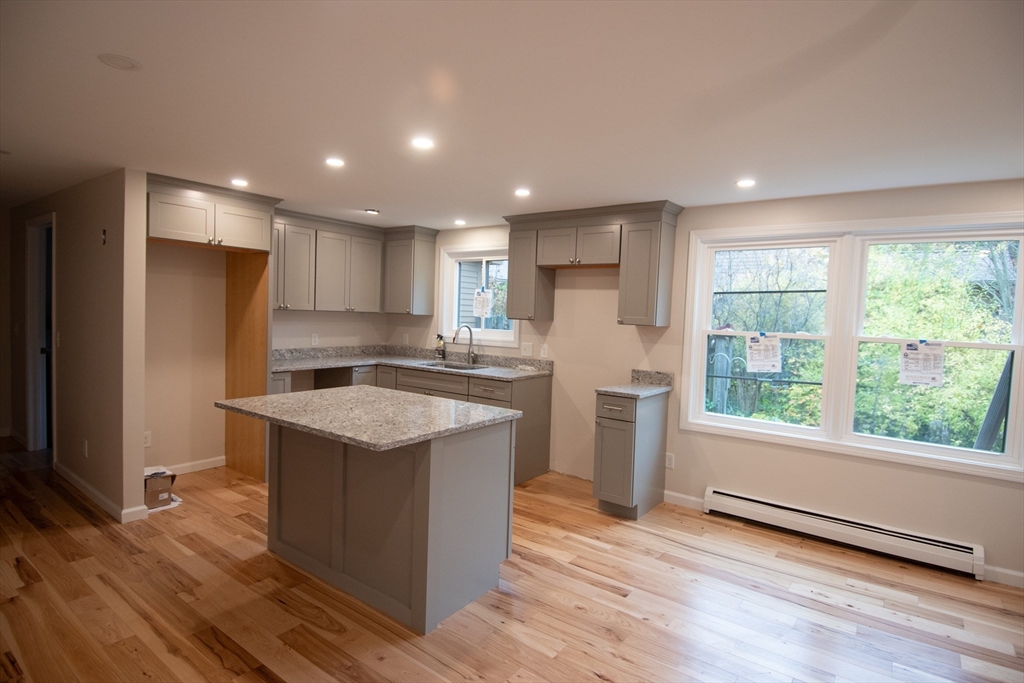 2 Mountain Rd Estates, Unit C Gill, MA 01354 - Photo 6 of 17 a kitchen with stainless steel appliances granite countertop a refrigerator a sink dishwasher and a oven with wooden floor