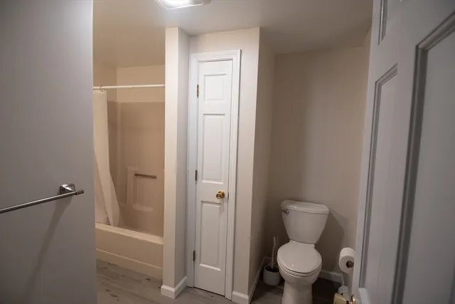 a bathroom with a toilet and a shower