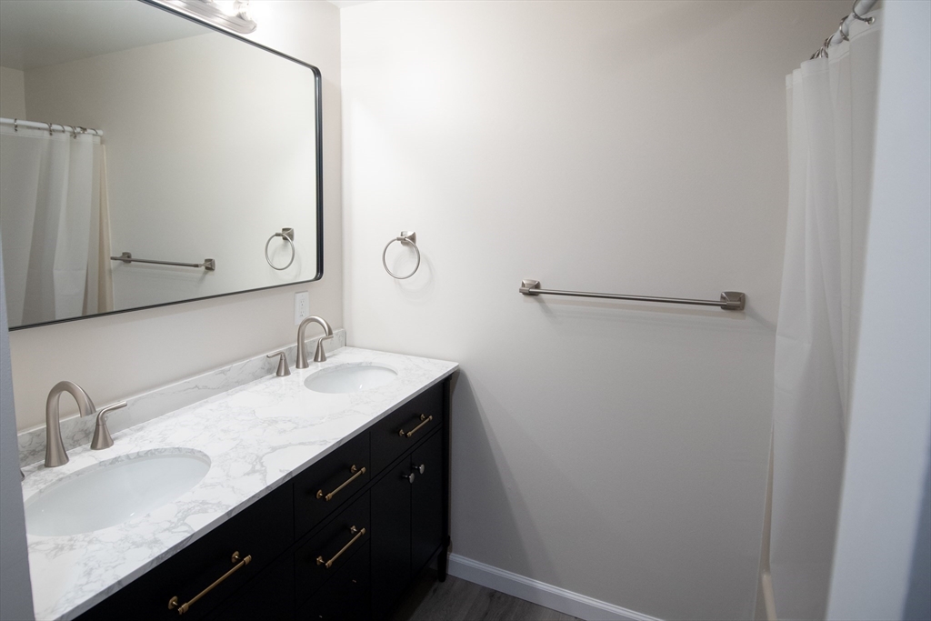 2 Mountain Rd Estates, Unit C Gill, MA 01354 - Photo 8 of 17 a bathroom with a granite countertop sink and a mirror