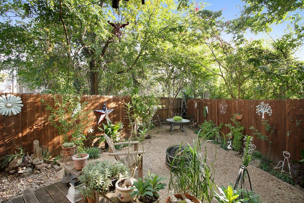 a backyard of a house with a yard and outdoor seating