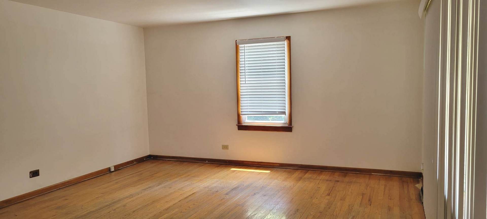7129 Clarendon Hills Road Darien, IL 60561 - Photo 2 of 9 an empty room with wooden floor and windows