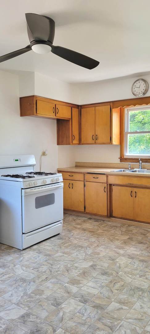 7129 Clarendon Hills Road Darien, IL 60561 - Photo 3 of 9 a kitchen with a stove a sink and a refrigerator