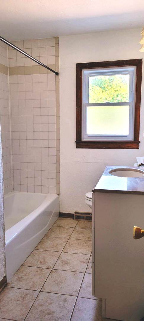 7129 Clarendon Hills Road Darien, IL 60561 - Photo 6 of 9 a bathroom with a bathtub and a shower