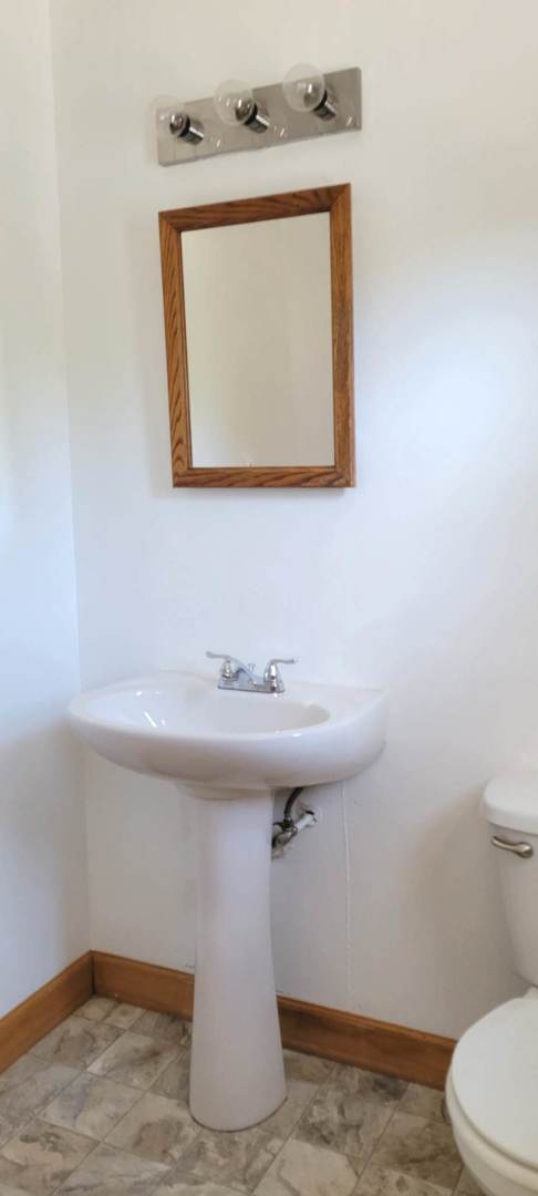 7129 Clarendon Hills Road Darien, IL 60561 - Photo 7 of 9 a bathroom with a sink and a toilet