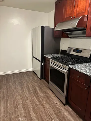 a kitchen with a stove and a refrigerator