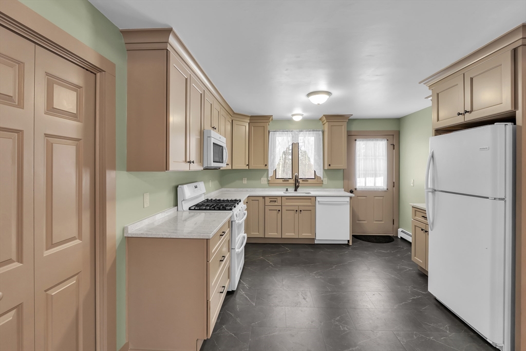 300 Padre Road New Braintree, MA 01531 - Photo 15 of 34 a kitchen with a refrigerator a sink and cabinets