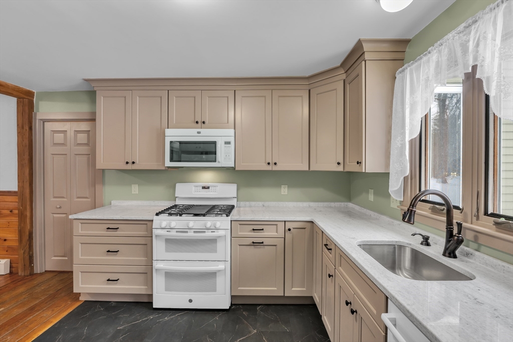 300 Padre Road New Braintree, MA 01531 - Photo 17 of 34 a kitchen with white cabinets and sink