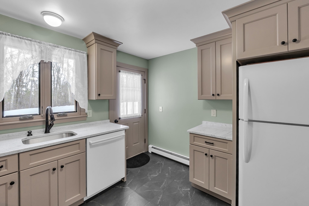 300 Padre Road New Braintree, MA 01531 - Photo 18 of 34 a kitchen with white cabinets and white appliances