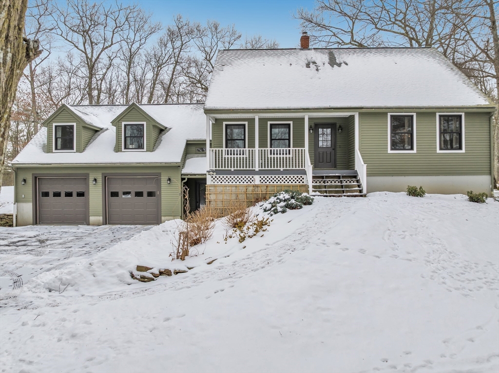 300 Padre Road New Braintree, MA 01531 - Photo 2 of 34 a front view of a house with a yard covered in snow