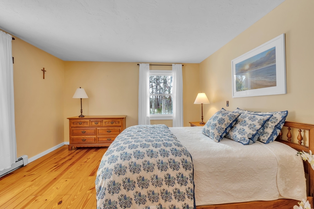 300 Padre Road New Braintree, MA 01531 - Photo 27 of 34 a bedroom with a bed and wooden floor