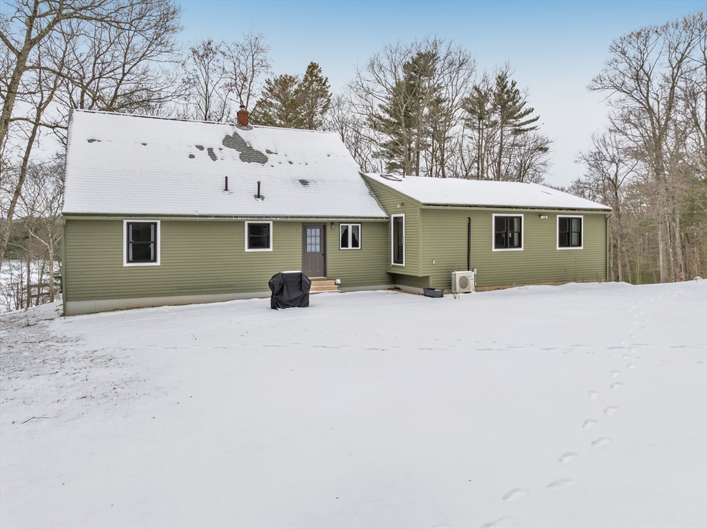 300 Padre Road New Braintree, MA 01531 - Photo 6 of 34 a view of a house with a yard covered in snow