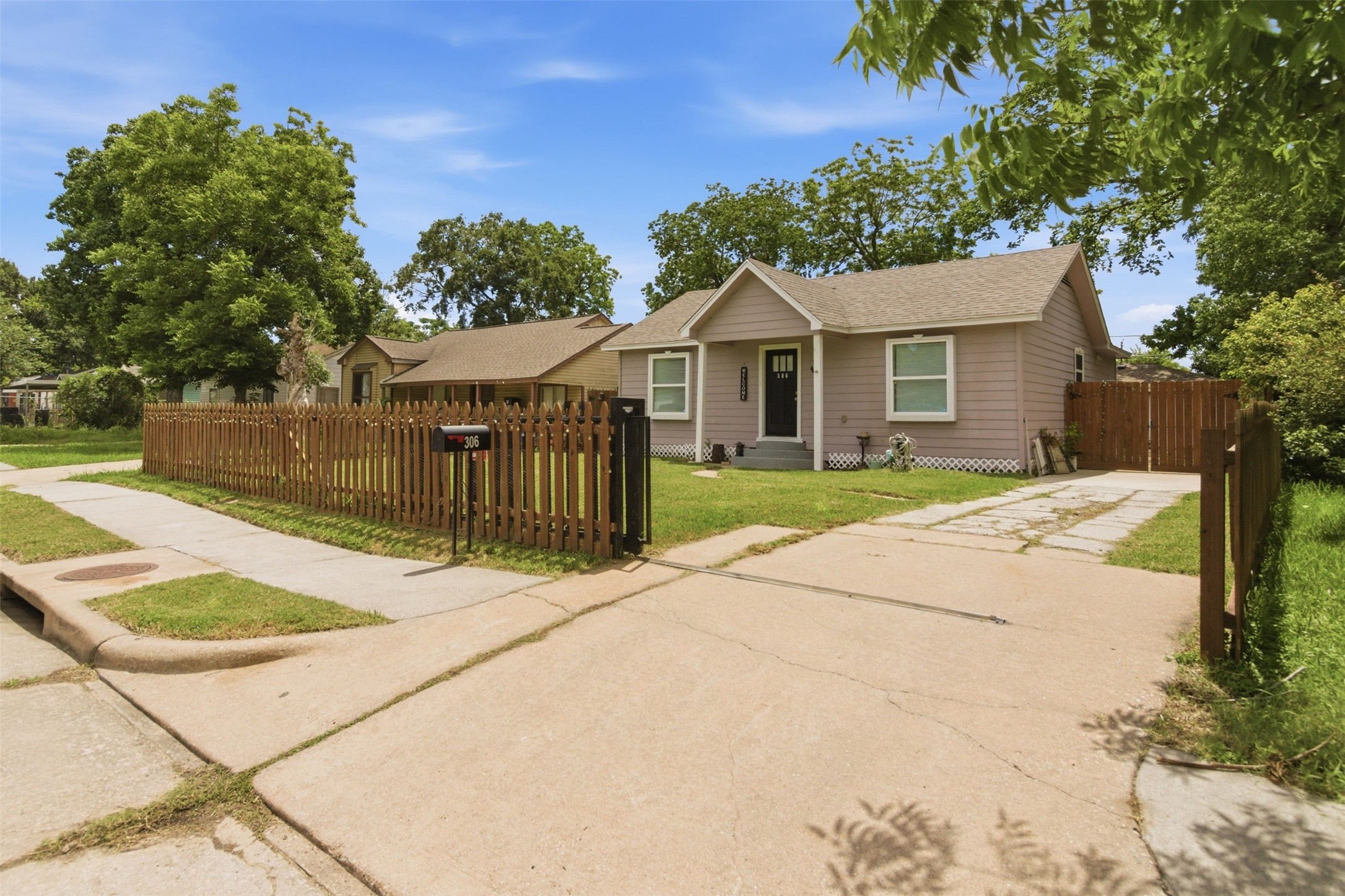 306 Center Street Pasadena, TX 77506 - Photo 2 of 31 a front view of a house with a yard and potted plants